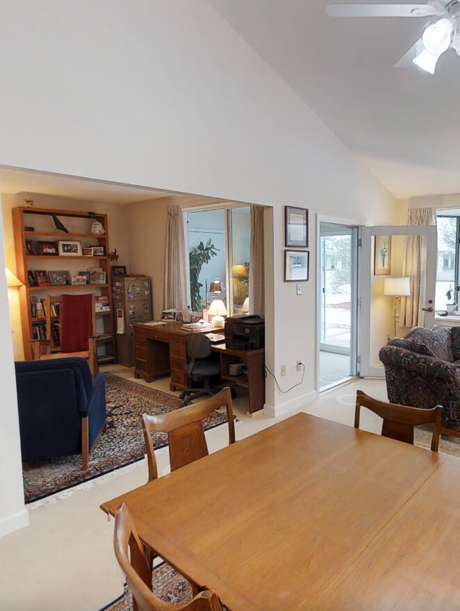 Cozy den off of the open concept living room / dining area looks out onto the enclosed patio in a One Bedroom plus den cottage.
